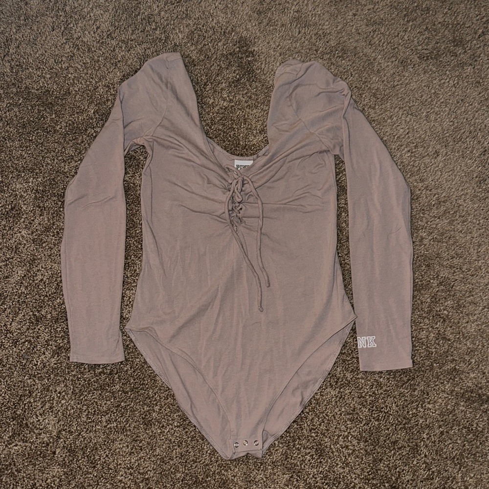 Victoria’s Secret cream colored body suit, tie up front with straps